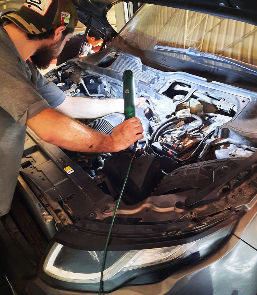 mechanic inspecting range rover car
